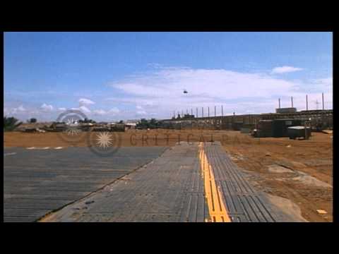 Sandbagged look up tower, building material and landing of armored helicopters at...HD Stock Footage