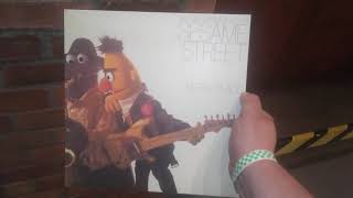Holding the B̶r̶u̶c̶e̶ ̶S̶p̶r̶i̶n̶g̶s̶t̶e̶e̶n̶ Sesame Street Album Born to R̶u̶n̶ Add, in the Sesame