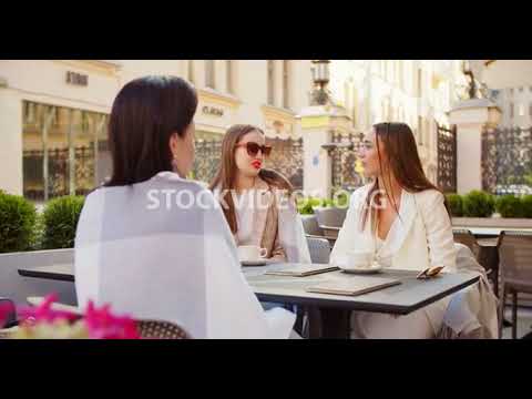 beautiful young woman having coffee talk...