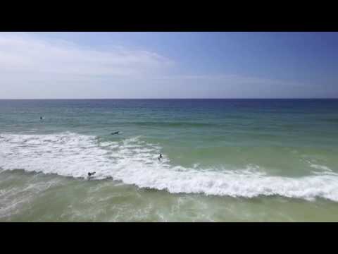 Drone shots of surfers and sands at Siouville