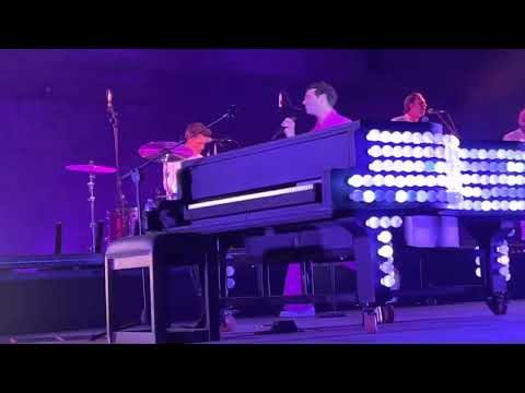 Mika performing Tiny Love in Carcassonne with colourful lights in the audience 22/7/2022