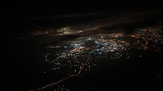 travel concept view from airplane window night city black clouds