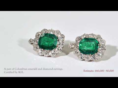 A pair of emerald and diamond cluster earrings.