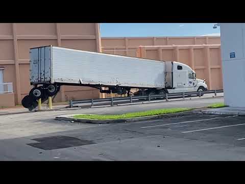 Semi-Truck Loses Back Wheels Trying to Turn Around Safety Barriers