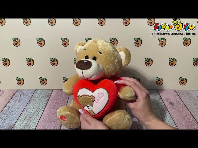 Игрушка мягкая Медведь бежевый с сердцем и красным бантом - видео