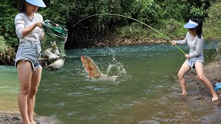The girl fishing caught a lot of fish under the river bridge.