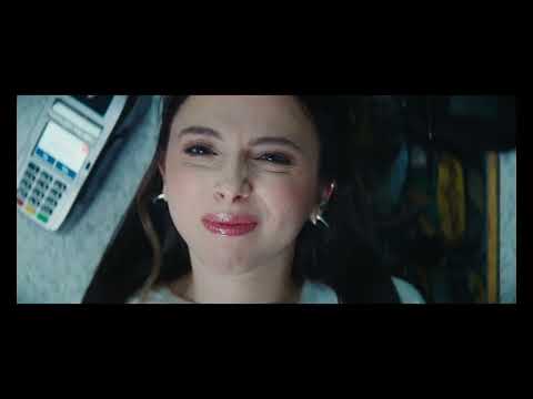 Drugstore June official trailer frame: June under drugstore fluorescents, synth pulse implied
