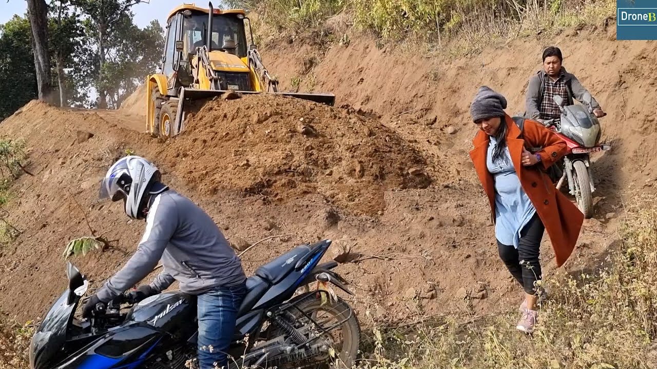 Busy and Only Mountain Road Connecting Rural Villages with Markets Reworking with JCB Backhoe