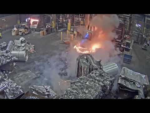 A smelter receives a huge spurt of molten metal on his forklift