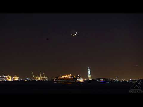 A Time-stack time-lapse of the crescent moon setting over the Statue of Liberty National Monument​