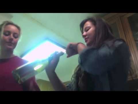 angel and nicole open a wine bottle