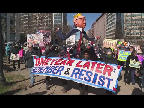 Protesters walk out to protest Trump's first year in office