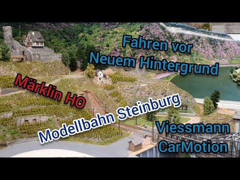 Modellbahn Steinburg.  Fahren vor neuem Hintergrund mit Viessmann CarMotion und Märklin H0.