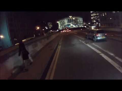 Driver pushes cyclist off the road whilst crossing solid white line.