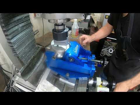 Machining pistons cutting valve reliefs.