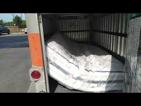 Part of a video titled A queen size mattress will fit in a 4x8 U-Haul trailer without the box 
spring.