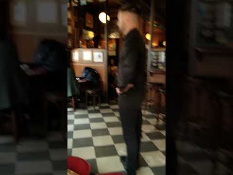 Bar Fight - Irish Pub Confrontation - Bartender Faces Off with Unruly Patron - Caught on Camera