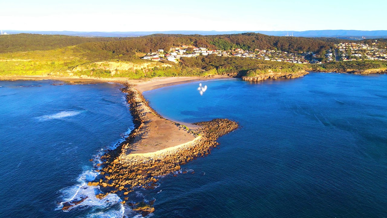 Discover the mesmerizing panoramas of Caves Beach.