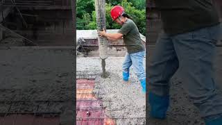 The concrete casting process for the iron framework of the building's roof to enhance its strength.