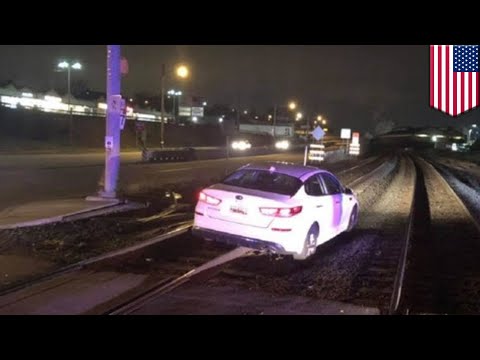 Woman drives onto train tracks because GPS said to - TomoNews