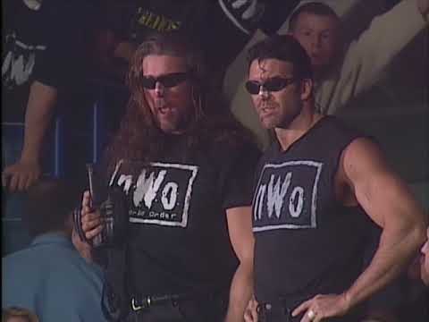 The Outsiders wave and taunt WCW Tag Champs Harlem Heat from the crowd 1996