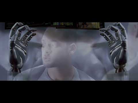 Trailer still: VIKI’s glowing core behind latticed catwalks; music implying choral gravity