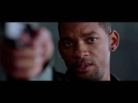 Trailer montage: glass atrium, descending freight of robots, and a leap framed by sun glare