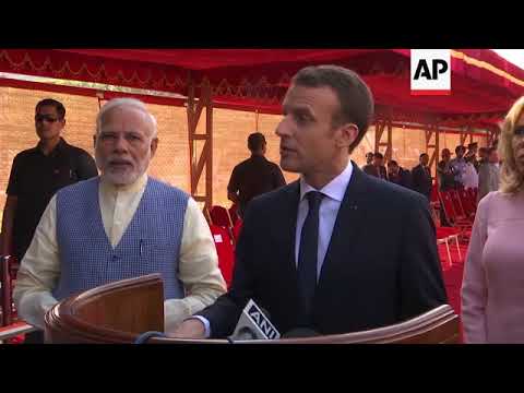 Macron given official welcome in New Delhi, lays wreath at Gandhi memorial