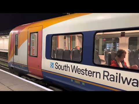 Class 444 arrives and departs Feltham for Woking
