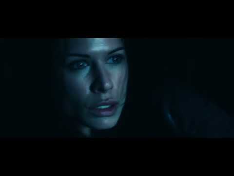 Official trailer image featuring Lucian and Sonja framed in torchlit stone halls
