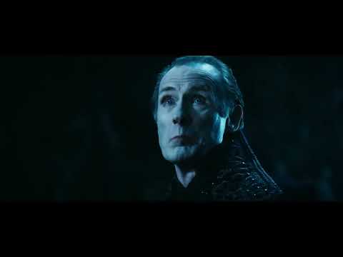 Trailer frame: Lucian in chains, flames behind, as drums escalate