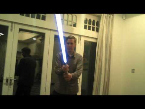 Jadell with a lightsaber in his kitchen