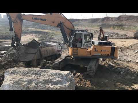 Liebherr 974 Excavator Loading Caterpillar Dumper 775E And Trucks - Kivos Ate