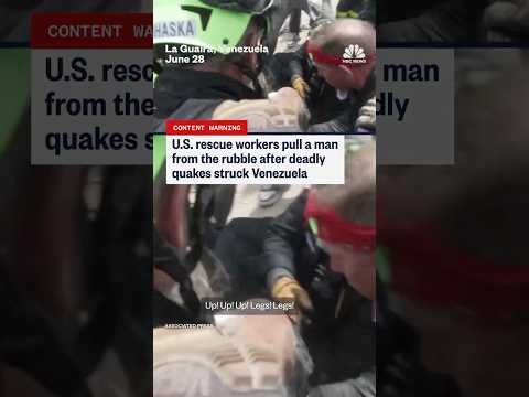 U.S. rescue workers pull a man from the rubble after deadly quakes struck Venezuela