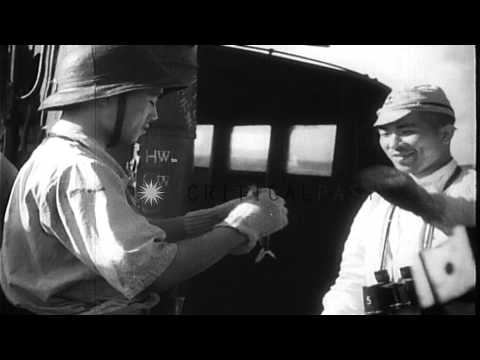 A man collects fish swept by water on the deck and crewmen dine aboard a Japanese...HD Stock Footage