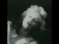 what type of animal is Marilyn Monroe playing with here in 1954?