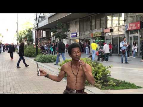 Crazy guy sticks a knife in his nose