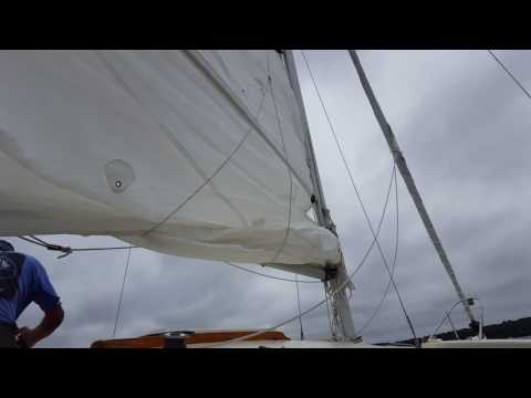 Finishing raising the sail on the Marples 26 constant camber Trimaran.