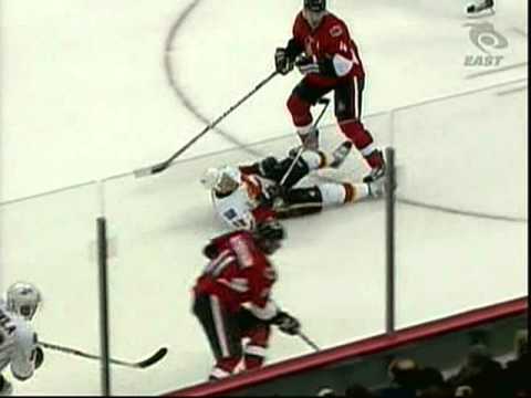 Chris Phillips hits Olli Jokinen