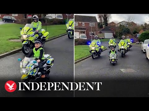 Young boy leads police patrol on electric motorbike he was given for Christmas