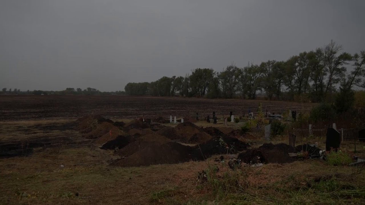 A Son and Daughter Bury Their Parents After the Hroza Strike