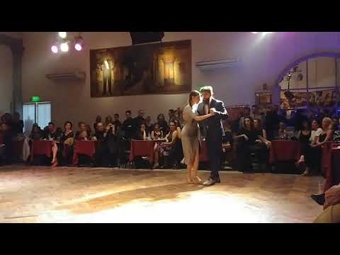  Mariela Soledad Chaves  and  Konstantinos Riginos  are  dancing  to  the  tango  "  Ansiedad  "  by  Juan D'Arienzo  in  2019