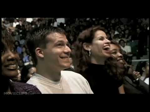 Trailer still — Steve Harvey on the Charlotte Coliseum stage as the crowd roars, with concert-film energy