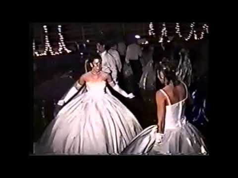Two ladies dancing in big white dresses