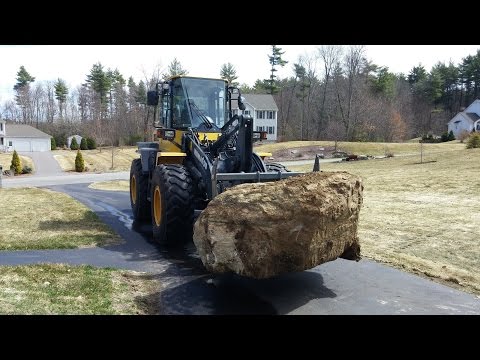Wheel Loader Loading Big Boulders Into Dump Trucks