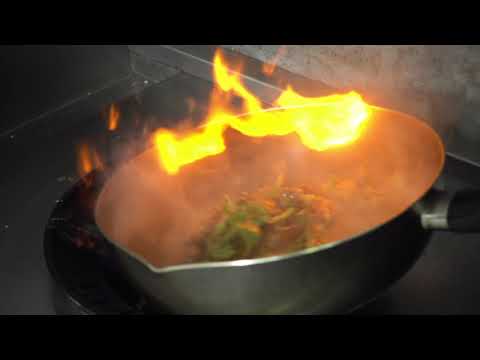 Slow Motion - Chef Cooking With Flame In A Frying Pan On A Kitchen Stove
