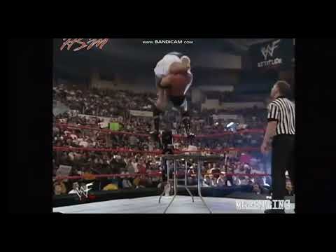 Hardcore Holly suplexes Al Snow through table