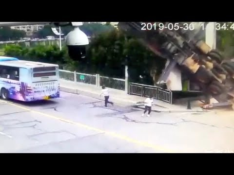 Men escape death after large crane flips over in east China