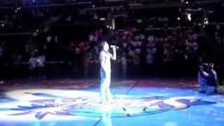 Jared Thomas singing at the Staples Center