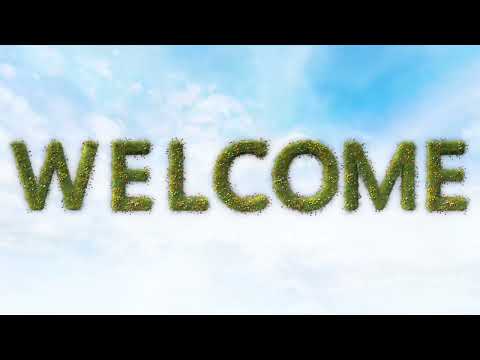 4K Green grass Welcome sign over blue sky video background 1 hour loop